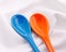 Blue ceramics spoon on white fabric background. Colorful concept