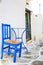 Blue chair and table on street of typical greek traditional village on Mykonos Island, Greece, Europe