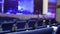 Blue chairs in a concert hall, blurred