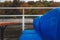 Blue chairs in raindrops on a pleasure boat in Moscow, autumn park in the background