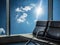 Blue chairs for sitting in the airport with blue sky and sunlight outside the window