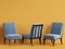 Blue chairs on yellow backgrond with copy space