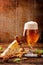 Blue cheese appetizer and beer on brown vintage background