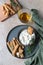 Blue cheese dressing or dip sauce with rosemary and gingerbread cookies sticks on concrete background. Selective focus. Top view