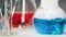 Blue chemical substance with smoke boils in laboratory, chemical experiment