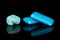 Blue chewing gum isolated on black glass
