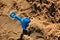 Blue childrens spatula, stuck in sand