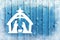 Blue Christmas background on wood table with Nativity scene and snowflakes