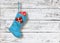 Blue christmas boot with gifts on wooden background