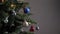 Blue christmas decorative ball on artificial tree branch