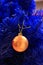 Blue christmas tree with yellow bulb. Blue artificial pine tree branch with golden ball. Festive happy new year decoration.