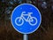 Blue circular road and traffic sign with bicycle icon