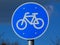Blue circular road traffic and sign with white border and bicycle symbol