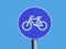 Blue circular traffic sign of bicycle lane or route with clear blue sky background