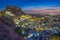 Blue city and Mehrangarh fort on the hill at night in Jodhpur