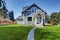 Blue clapboard siding house with grass filled front yard.