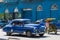 Blue classic car drives in province Villa Clara in Cuba on the street