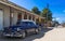 Blue classic car with white roof parked in havana Cuba with street life view