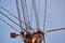 Blue clear sky and pole with large bundle of electric wires.