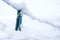 Blue clothes peg covered with snow hanging on a clothesline in winter  copy space  selected focus