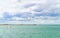 Blue clouded sky, clear sea water, panoramic skyline.