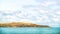 Blue clouded sky, clear sea water, panoramic skyline, sea-gulls, coast view from a sea.