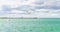 Blue clouded sky, clear sea water, panoramic skyline, sea-gulls, coast view from a sea.