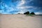 Blue clouded sky over sand dunes