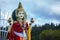 Blue cloudy sky in Mauritius with Goddess Maha Luxmi`s statue in the background.