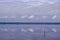 Blue cloudy sky mirror image reflection in Sanguinet lake in France