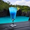 Blue Cocktail Blue Lagoon with ice in the glass. Resort tropical hotel in summer day, blurred background, generative AI.