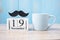 Blue coffee cup, Black mustache and 19 November Calendar.  in the morning. Father, International men day, Prostate Cancer