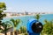 Blue Coin Operated Telescope Of Panoramic Tropical City And Ocean