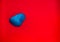 Blue color Natural Pebbles isolated on red background with space for copy text and words. Multi color Natural Pebbles stone. Blue