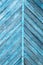 Blue color old wooden diagonal symmetrical planks with peeled paint background