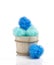 Blue color sponges into a wood basket against bathroom ambiance