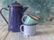 Blue colored enamel teapot and mugs on a wooden table