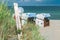 Blue colored roofed chairs on sandy beach in Travemunde, Germany. Welcome balloons