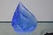 Blue coloured piece of raw glass looking like a crystal, coloured blue by adding cobalt oxide