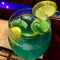 A blue coloured sparkling mocktail with lemon