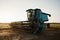 Blue combine harvester agriculture machine harvesting in a field