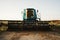 Blue combine harvester agriculture machine harvesting in a field