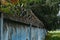 Blue concrete fence with barbed wires.