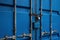 Blue Container Door with Rusty Chain and Locked Padlock