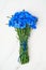 Blue Cornflower bouquet on white wooden background. Top view, co