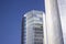 Blue corporate building with a frontal blue glass window wall.