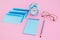 Blue correspondence envelopes, clock and notebook on pink background with copy space. Back to school or work concept