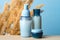 Blue cosmetic bottles set and jar with natural organic cream. Beauty product packages collection, blank templates of transparent