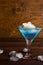 Blue cosmopolitan cocktail on wooden background