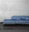 Blue couch against stone wall